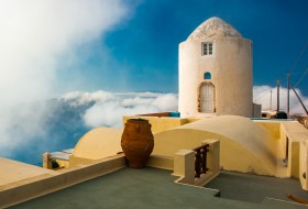 Santorini - A former windmill in the clouds.
